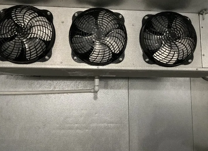 Close-up of evaporator coil fans inside a walk-in freezer in Northern Illinois